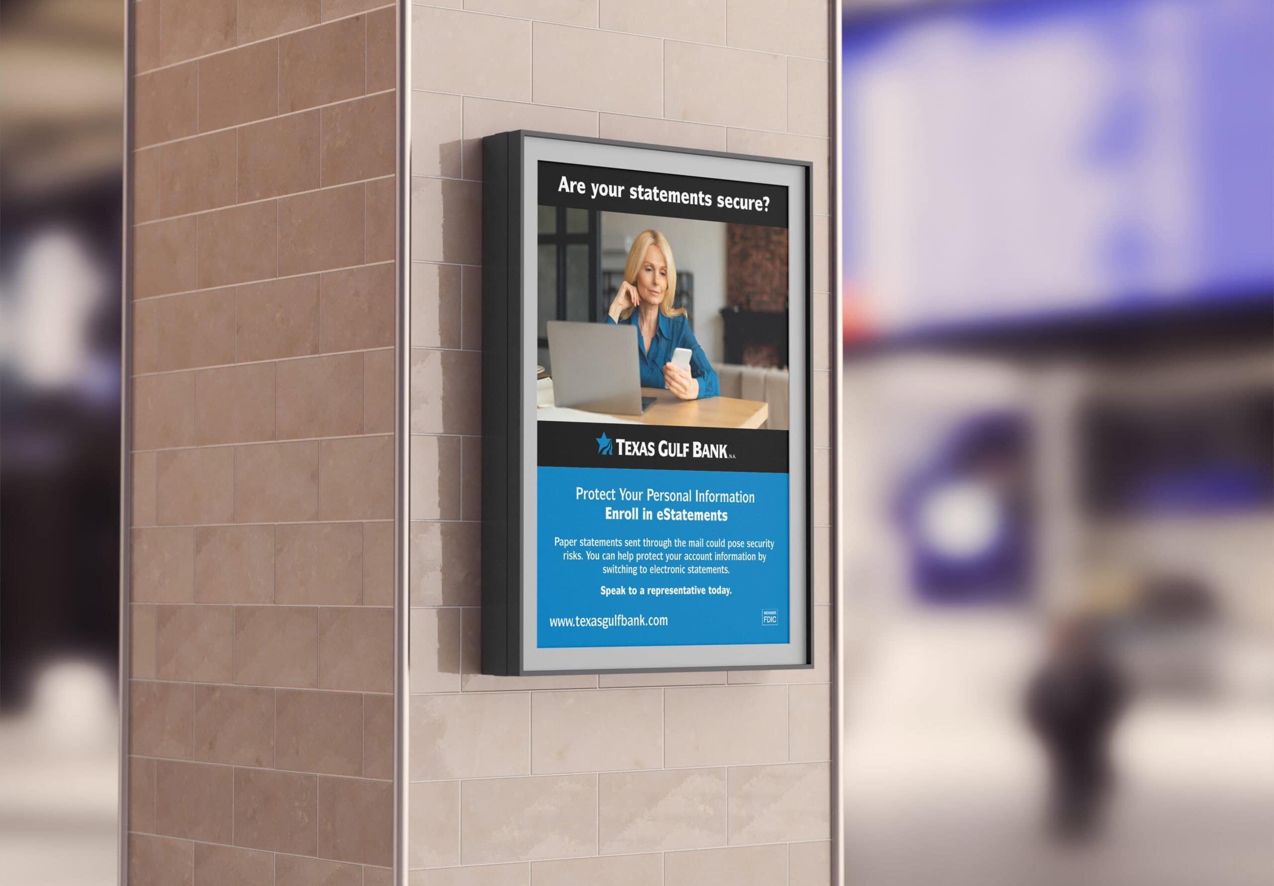 A poster for Texas Gulf Bank on a tiled pillar displays a woman on the phone with a laptop, promoting e-statements and urging customers to protect personal information by enrolling online. - Market Design Team: Define. Structure. Expand.