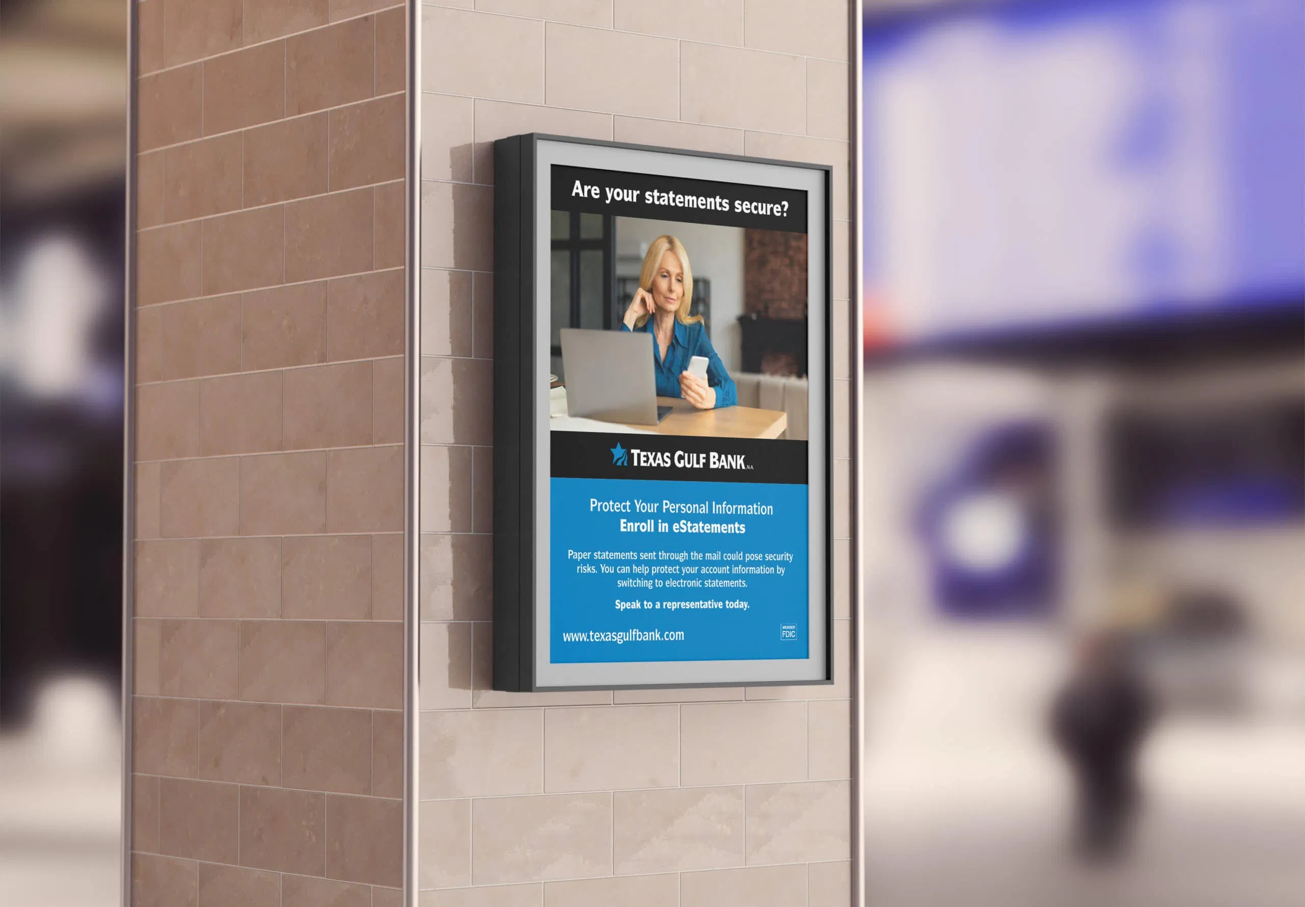 A poster for Texas Gulf Bank on a tiled pillar displays a woman on the phone with a laptop, promoting e-statements and urging customers to protect personal information by enrolling online. - Market Design Team: Define. Structure. Expand.