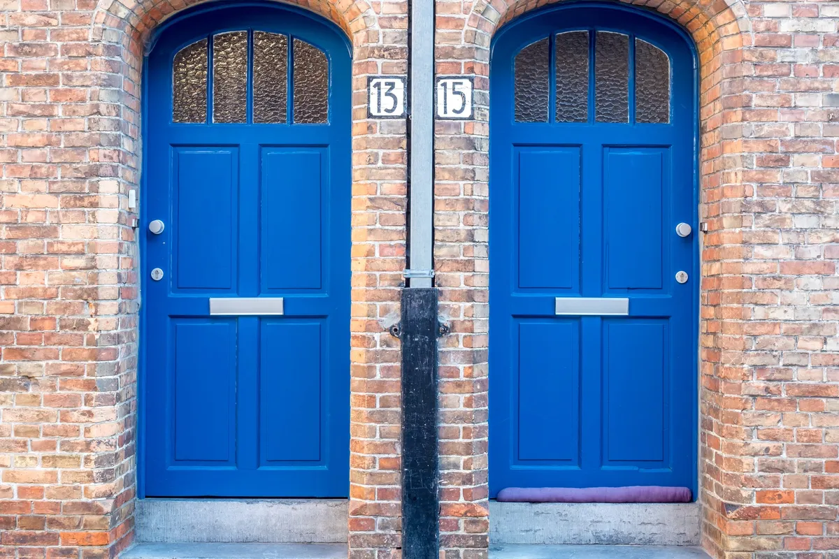 A vibrant front door in a European-style home, symbolizing the welcoming aspect of effective branding.