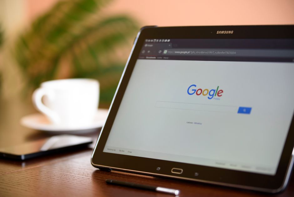 a samsung tablet displaying the google homepage on a desk with a coffee cup and a stylus, highlighting services for lake jackson seo. market design team: define. structure. expand.