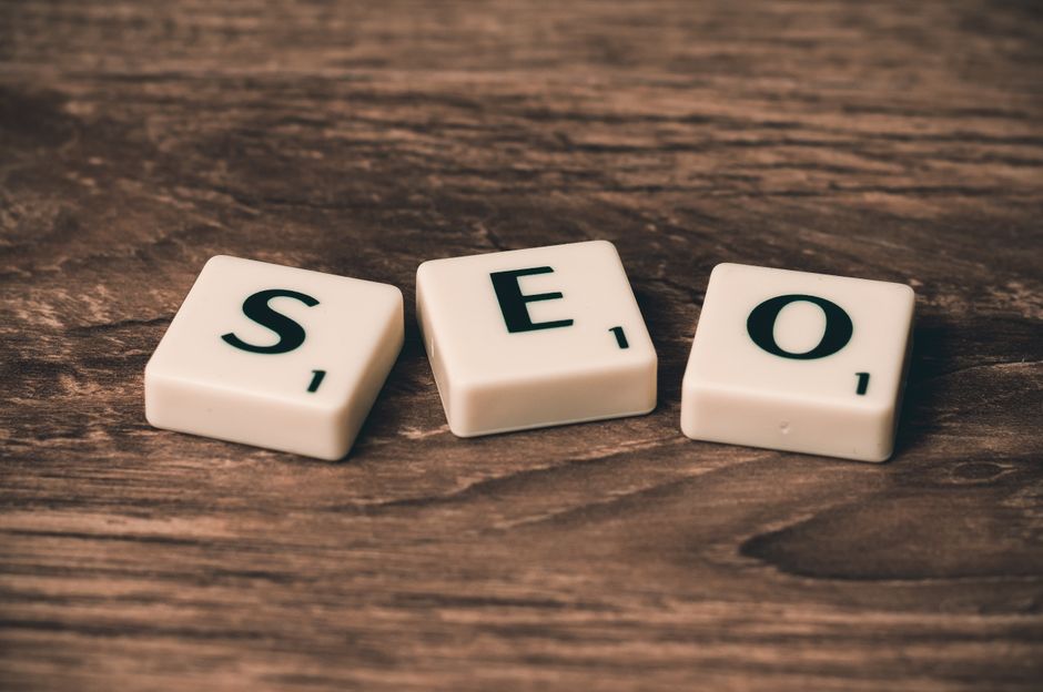 scrabble tiles spelling “seo” on a wooden surface, representing professional seo services. market design team: define. structure. expand.
